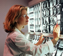 Doctor looking at MRIs Doctor looking at MRIs